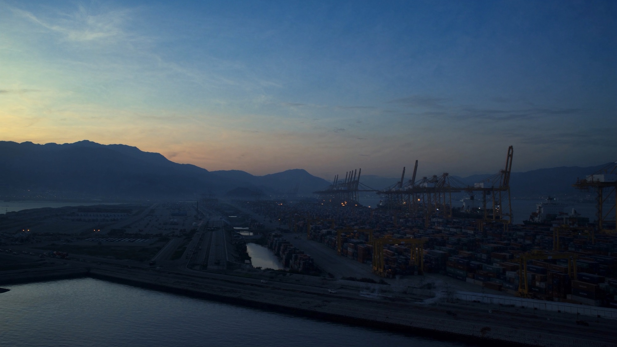 Aerial view of an international shipping port, representing New Nexus's cross-border trade network